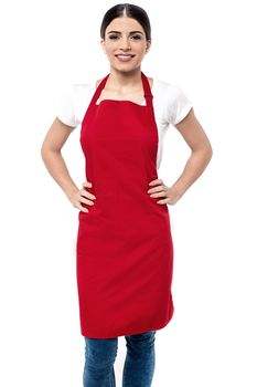 Happy female chef with hands on her waist