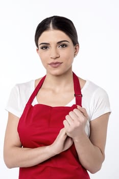 Young female chef with her hands clasped