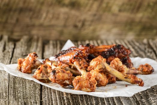 Pile of bones from already eaten barbecued chicken wings.