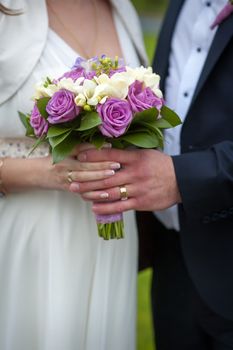 Beautiful wedding bouquet in brides and grooms hands.