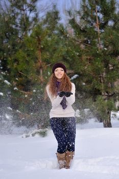 girl standing on background winter trees in park