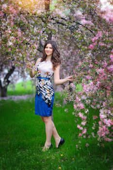 beautiful brunette girl in the flowered garden.