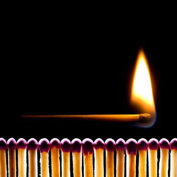 It is a lot of matches on a black background. One match burns.