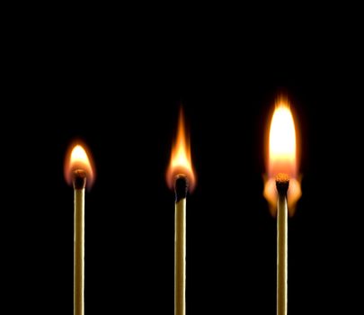 Three matches on a black background. Beautiful fire.