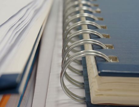 Blue sky color cover note book placed on desk at office.                                