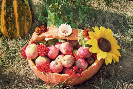 Large ripe apples are in a wattled basket sold at the fair.