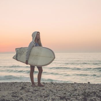 A beautiful girl at the beach with her bodyboard