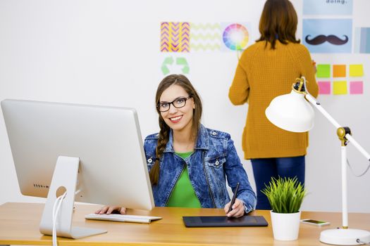 Women working at desk In a creative office, team work 