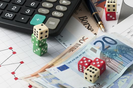 This is a view with the dice game and the game in play the stock market with finance graphs, coins and banknotes