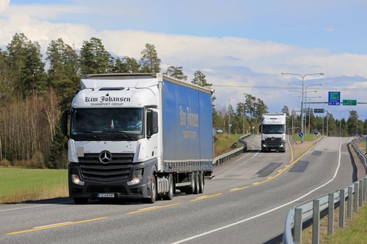 KAARINA, FINLAND - MAY 3, 2015: Two Mercedes-Benz Actros trucks of Kim Johansen Transport Group. The Danish company has focus on transport of time sensitive goods within Europe.
