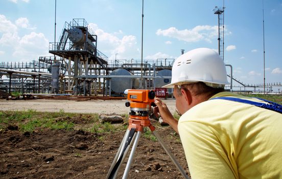 Industry worker working with theodolite outdoors