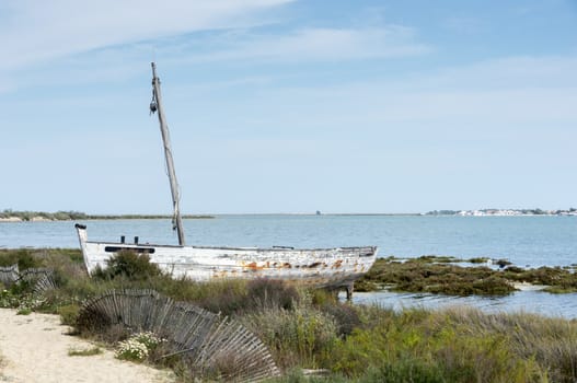 old fisher boat on the beach in tavira portugal algarve area