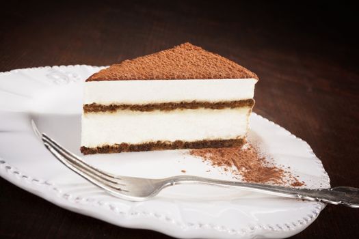 Tiramisu dessert on chocolate bar isolated on white background. Italian sweet dessert concept.