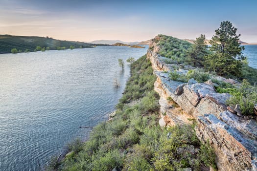 sandstone cliff and lake at dusk - Horsetooth Reservoir near Fort Collins, Colorado, at springtime