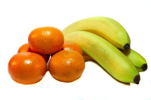 Orange tangerine and yellow bananas on a white background