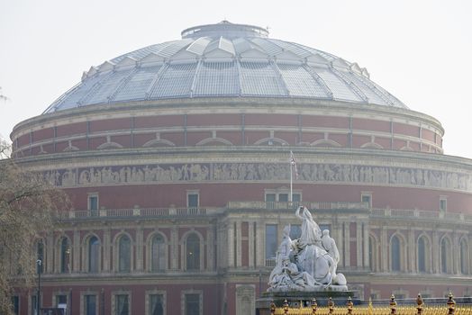 Albert Memorial statue overlooking hazy Royal Albert Hall, in London. The concert hall is home to the Proms, which take place each summer since 1941.