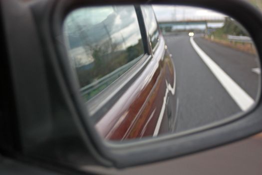 highway from the mirror of the car