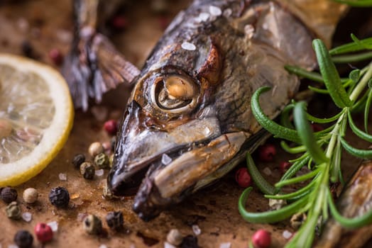 Baked Fish with Spice, Lemon and Rosemary on a Roaster Pan with Baking Paper