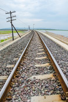 Railroad tracks into the reservoir, Pa Sak Jolasid Dam, Lopburi Thailand.