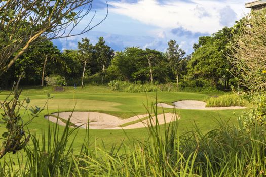 Beautiful View of Green Golf Field with Blue Sky.