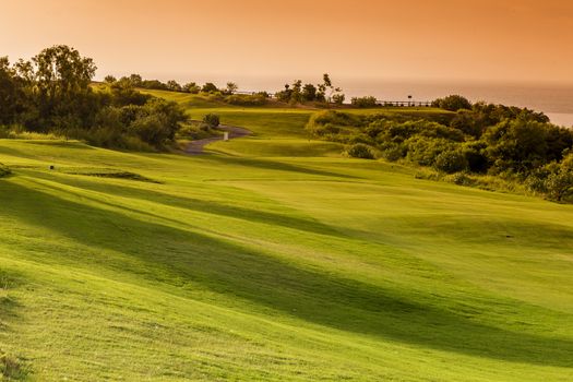 Beautiful View of Green Golf Field with Blue Sky.