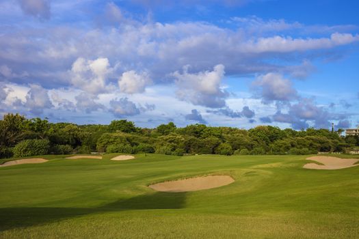 Beautiful View of Green Golf Field with Blue Sky.