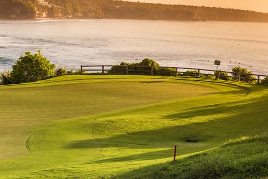 Beautiful View of Green Golf Field with Blue Sky.