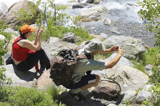 Group of tourists making a snap shot on the mountain road