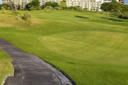 Beautiful View of Green Golf Field with Blue Sky.