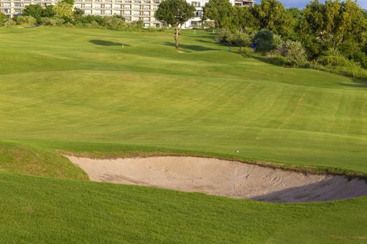 Beautiful View of Green Golf Field with Blue Sky.