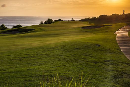 Beautiful View of Green Golf Field with Blue Sky.