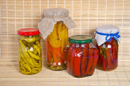 Ecologic chilli peppers paprika vegetables preserved  glass pots group