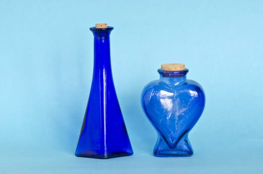 two beautiful blue decorative glass bottle on azure background