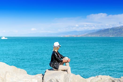 The back of an attractive young woman looking at the ocean view