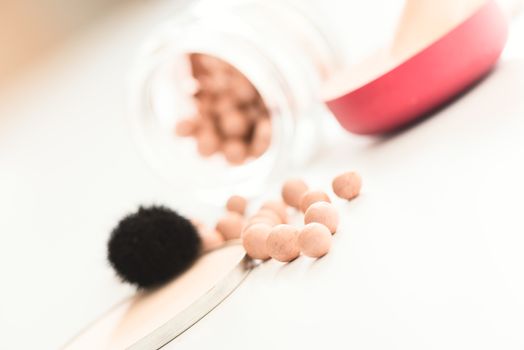 The bronzing pearls in jar and makeup brush