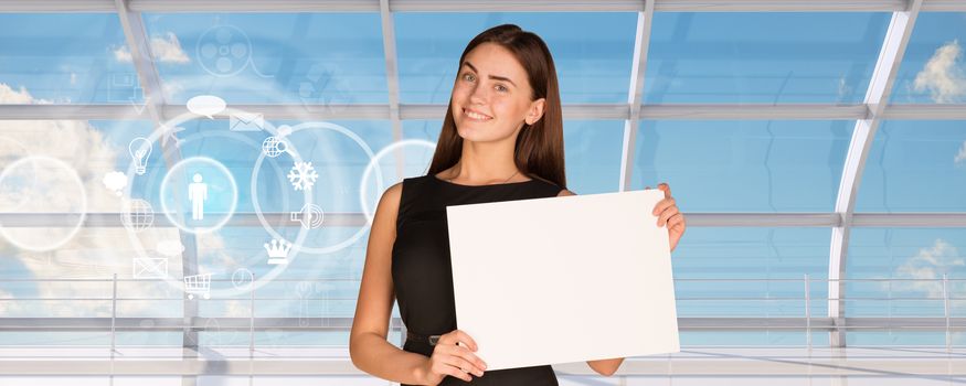 Smiling young businesswoman holding blank paper on window blue sky background