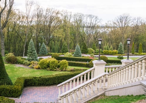 beautiful staircase in courtyard with green garden on background