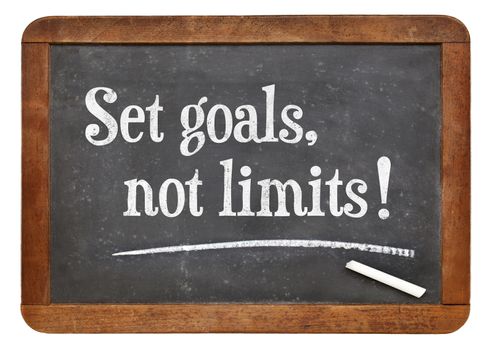 Set goals, no limits. Motivational words  on a vintage slate blackboard