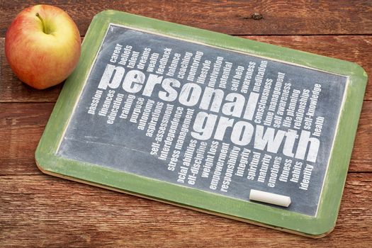 personal growth word cloud on a slate blackboard with apple