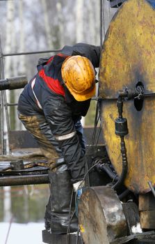 People at work. Worker works on an oil refinery.
