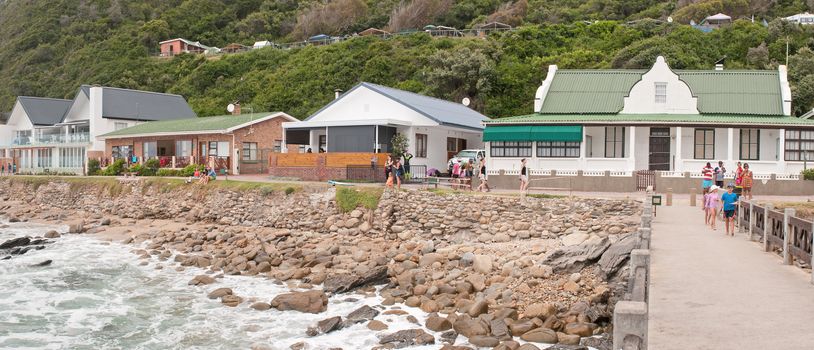 GEORGE, SOUTH AFRICA - JANUARY 3, 2015: Unidentified people, holiday homes and a caravan park at the beach at Victoria Bay