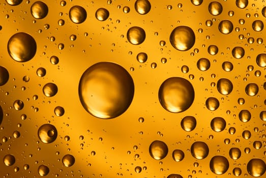golden water drops on glass,could be used as background