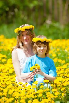 Boy and his Mother Sitting in a Dandelion Field
