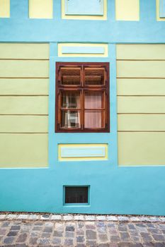 Sighisoara, Romania - June 23, 2013: Blue house facade with wooden window from Sighisoara city old center, Transylvania, Romania