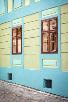 Sighisoara, Romania - June 23, 2013: Blue house facade with wooden windows from Sighisoara city old center, Transylvania, Romania