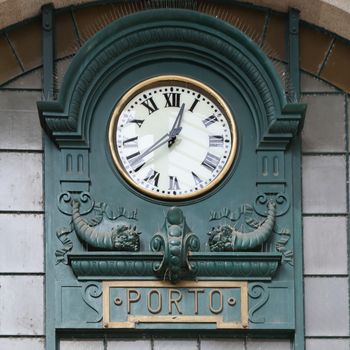 Old clock at railway station in Porto, Portugal


