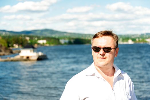 Middle aged man portrait with sea at background