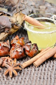 Set with star anise, fried chestnut, honey and cinnamon sticks close up