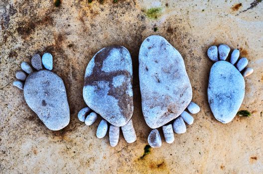 Four stone footprints in the sandy beach