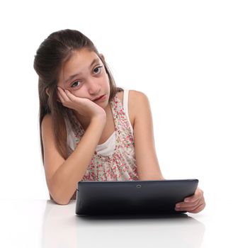 Boring. Pre-teen girl with a tablet computer. Isolated on white